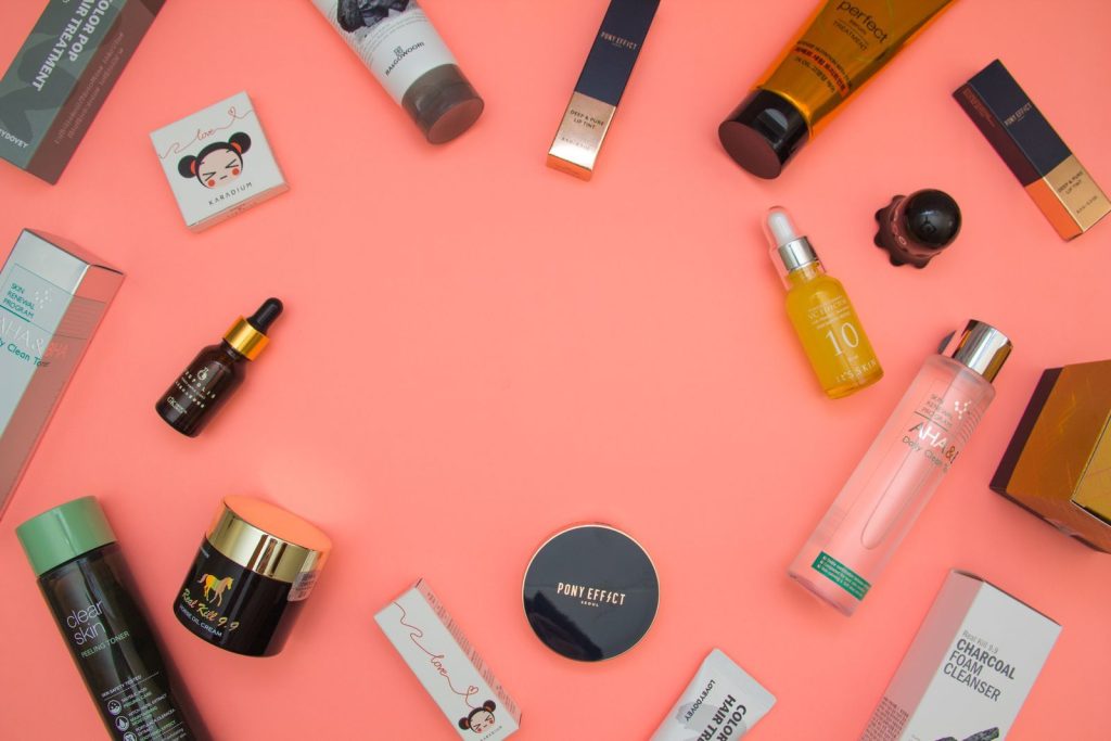 Beauty products arranged on a pink table