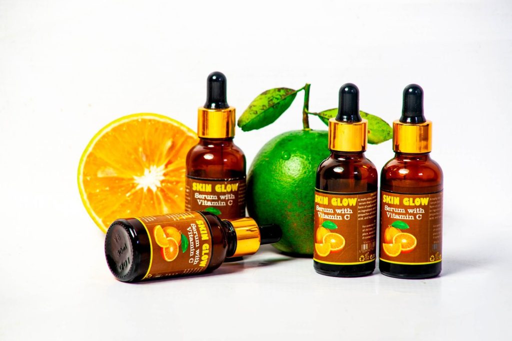 Serum bottles with fresh citrus fruits